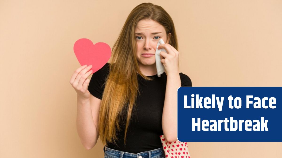 A sad young woman holds a heart-shaped paper gift after recent heartbreak on Valentine's Day.